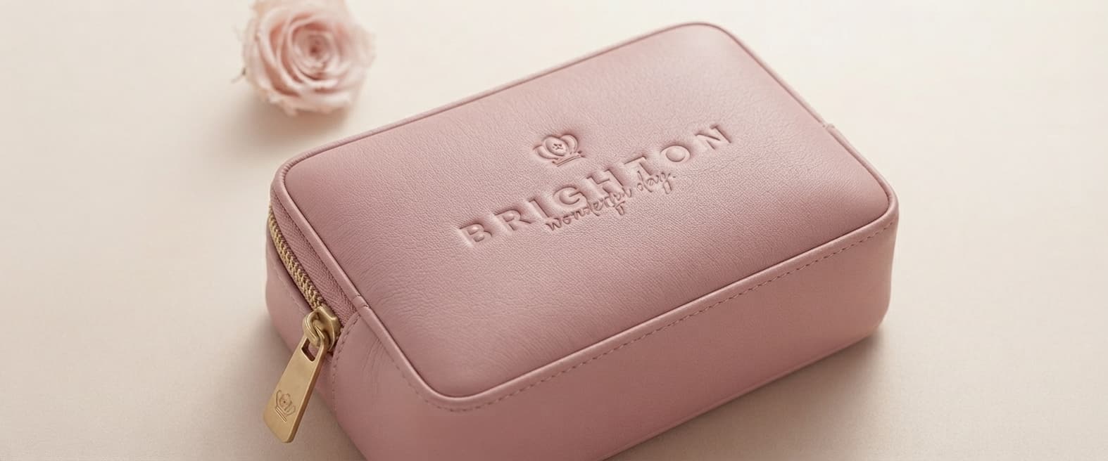 Brighton pink leather pouch with an embossed crown logo