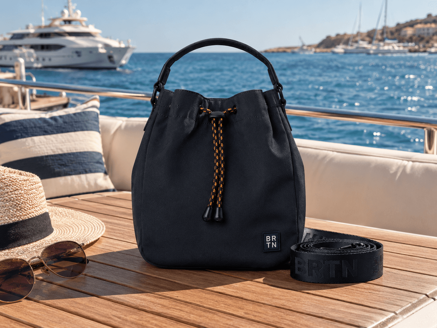Brighton navy bucket bag aboard a yacht overlooking a marina