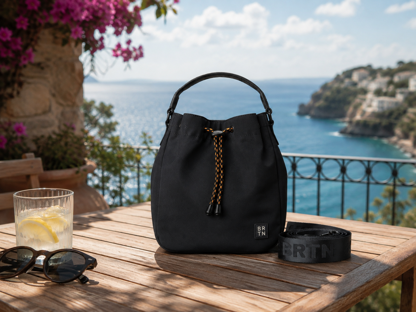 Brighton black bucket bag on a Mediterranean terrace table